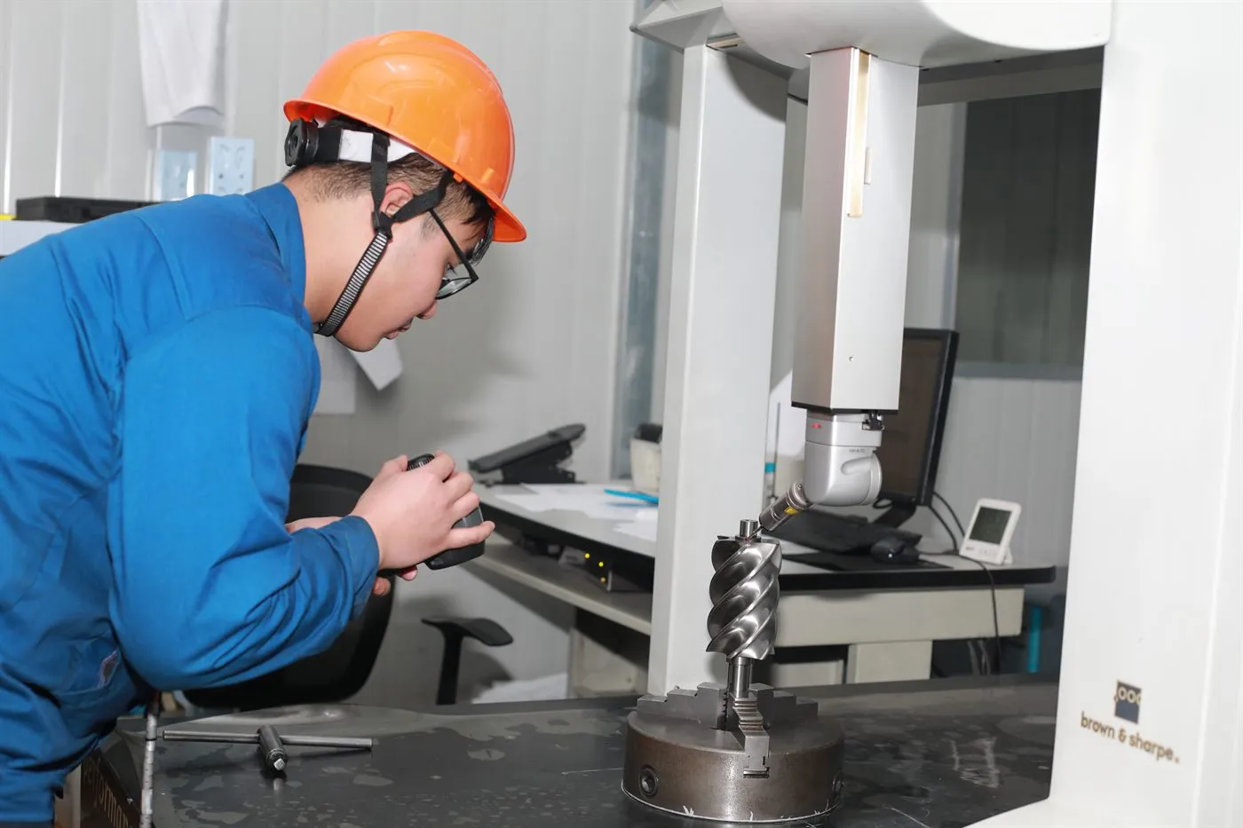 Air compressor 31 Quality technician measuring a screw compressor rotor on a coordinate measuring machine
