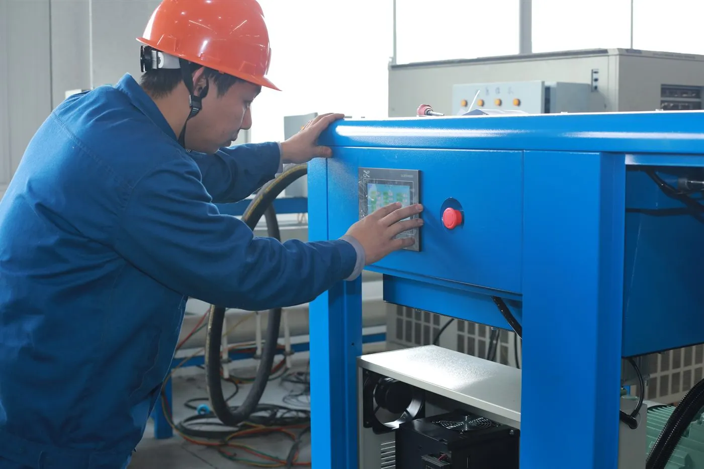 Air compressor 34 Technician operating the touchscreen controller during an industrial air compressor function test