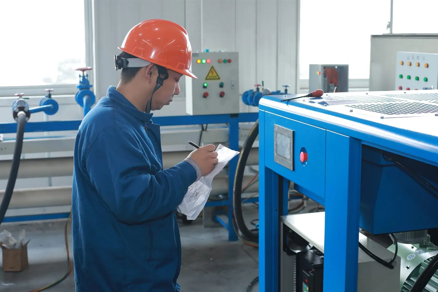 Air compressor 35 Factory technician recording industrial air compressor performance test data