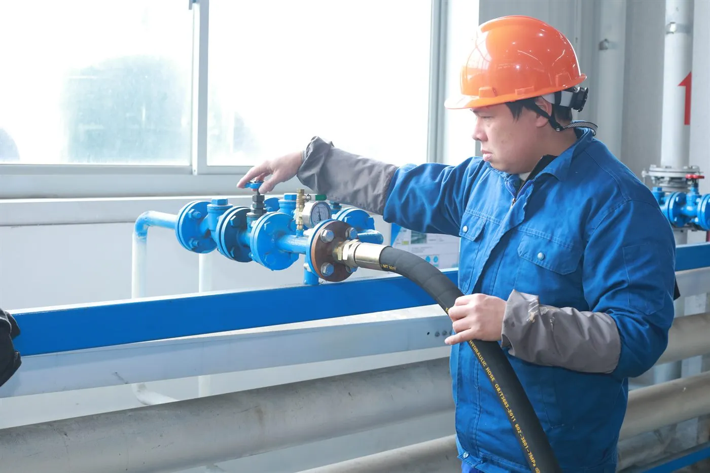 Air compressor 36 Technician checking an industrial air compressor pressure-test manifold and high-pressure hose