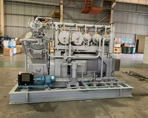 Reciprocating piston compressor for high flow applications